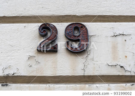 Number twenty nine on peeling wall by doorway 93199002