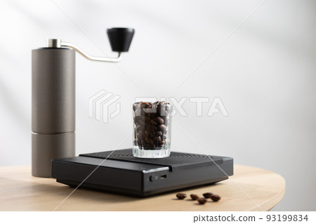 Dark roasted coffee beans in a clear glass Dark roasted coffee beans in a clear glass 93199834