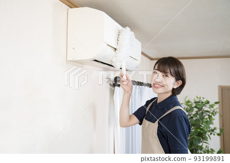 House cleaning woman cleaning the air conditioner with a mop House cleaning woman cleaning the air conditioner with a mop 93199891