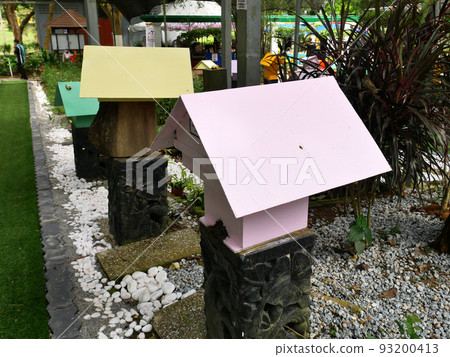 SERDANG, MALAYSIA -JUNE 7, 2022: Heterotrigona Itama or known as Stingless Bee. Man-made nests made of wood and colored colorfully to look attractive. it is farmed to get its honey. 93200413