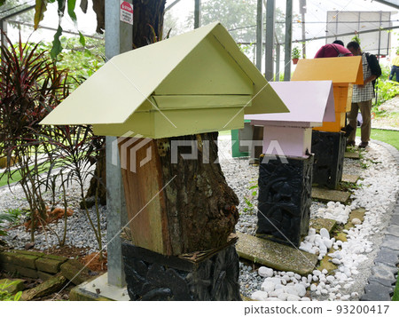 SERDANG, MALAYSIA -JUNE 7, 2022: Heterotrigona Itama or known as Stingless Bee. Man-made nests made of wood and colored colorfully to look attractive. it is farmed to get its honey. 93200417