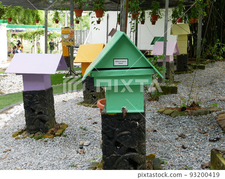 SERDANG, MALAYSIA -JUNE 7, 2022: Heterotrigona Itama or known as Stingless Bee. Man-made nests made of wood and colored colorfully to look attractive. it is farmed to get its honey. 93200419