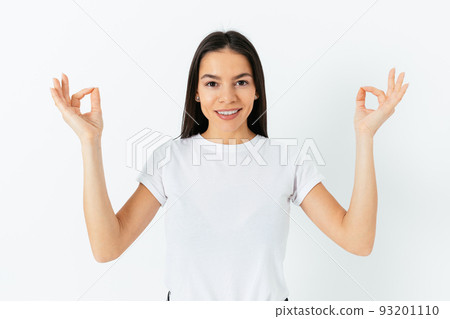 Portrait of happy serene young woman meditating Portrait of happy serene young woman meditating 93201110