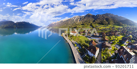 Stunning idylic nature scenery of lake Brienz with turquoise waters. Switzerland, Bern canton. village surrounded turquoise waters ,aerial view 93201711