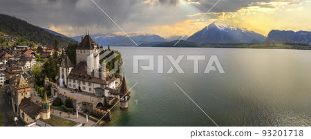 Aerial view of amazing romantic castle Oberhofen over sunset light. scenic Thun lake, Switzerland. 93201718