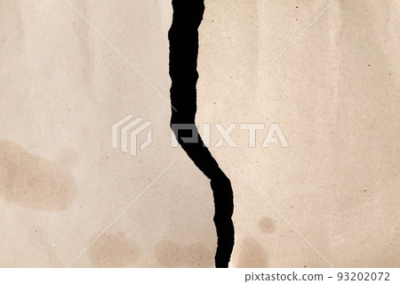 A sheet of brown kraft paper torn into two halves. Crumpled oily rough paper on a black background A sheet of brown kraft paper torn into two halves. Crumpled oily rough paper on a black background 93202072