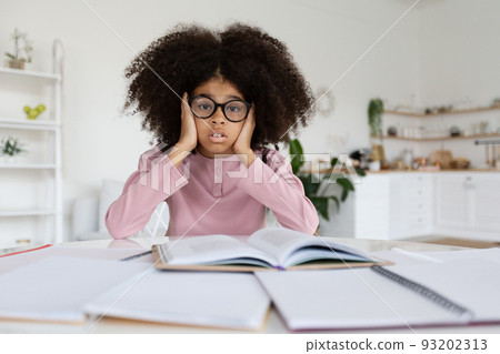 Overwhelmed african american school girl doing homework 93202313