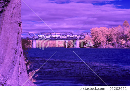 Infrared photograph of a commuter train on the Victoria Bridge crossing the Nepean River in Penrith in Australia 93202631