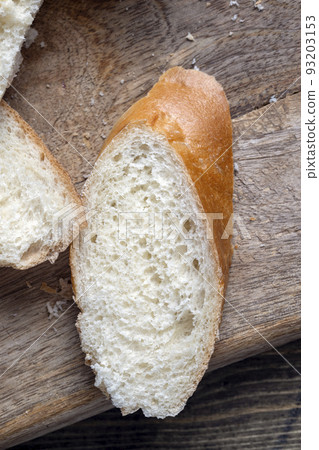 a wheat baguette cut into pieces, close up 93203153