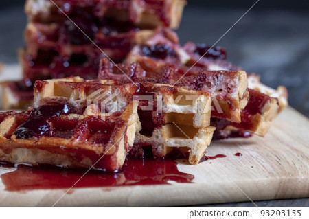 soft waffles with red cherry jam on a serving board soft waffles with red cherry jam on a serving board 93203155