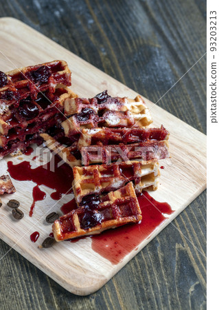soft waffles with red cherry jam on a serving board soft waffles with red cherry jam on a serving board 93203213