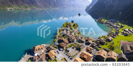 Stunning idylic nature scenery of lake Brienz with turquoise waters. Switzerland, Bern canton. Iseltwald village surrounded turquoise waters ,aereal view Stunning idylic nature scenery of lake Brienz with turquoise waters. Switzerland, Bern canton. Iseltwald village surrounded turquoise waters ,aereal view 93203845
