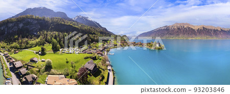 Stunning idylic nature scenery of lake Brienz with turquoise waters. Switzerland, Bern canton. Iseltwald village surrounded turquoise waters ,aereal view Stunning idylic nature scenery of lake Brienz with turquoise waters. Switzerland, Bern canton. Iseltwald village surrounded turquoise waters ,aereal view 93203846