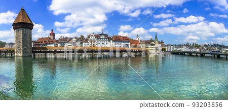 Panoramic view of Lucerne (Luzern) town with famous Chapel wooden bridge over Reuss river.  Switzerland travel and landmarks. 93203856