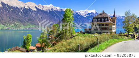 Stunning idylic nature scenery of lake Brienz with turquoise waters. Switzerland, Bern canton. Iseltwald village Stunning idylic nature scenery of lake Brienz with turquoise waters. Switzerland, Bern canton. Iseltwald village 93203875