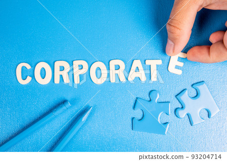 Corporate. Text from white wooden letters on a blue background Corporate. Text from white wooden letters on a blue background 93204714