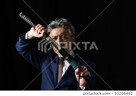 A man with a Japanese sword Black background 93206492