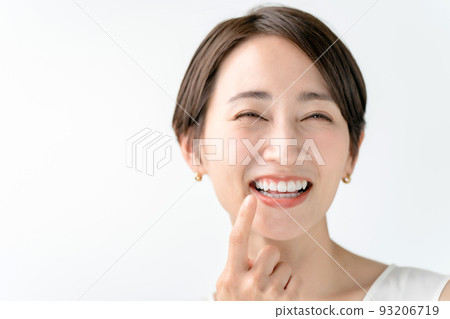 Woman checking her teeth White background 93206719