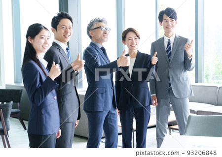 Business person giving thumbs up and cheering 93206848