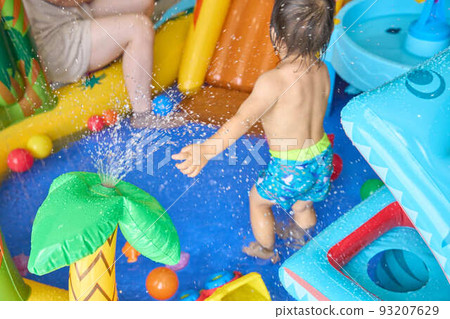 Playing in the water/pool at home 93207629