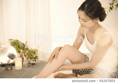 Young woman doing leg skin care 93207803