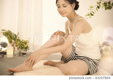 Young woman doing leg skin care 93207804