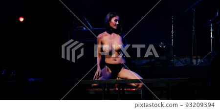 Asian women dancing sexy on stage in bright lights at the music festival Asian women dancing sexy on stage in bright lights at the music festival 93209394