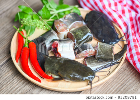 catfish fillet on wooden plate, fresh raw catfish menu freshwater fish, catfish for cooking food, fish chopped with ingredients herb and spices catfish fillet on wooden plate, fresh raw catfish menu freshwater fish, catfish for cooking food, fish chopped with ingredients herb and spices 93209781
