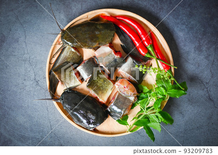catfish fillet on wooden plate, fresh raw catfish menu freshwater fish, catfish for cooking food, fish chopped with ingredients herb and spices catfish fillet on wooden plate, fresh raw catfish menu freshwater fish, catfish for cooking food, fish chopped with ingredients herb and spices 93209783