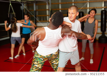 Men doing strength techniques in self defense training 93211355