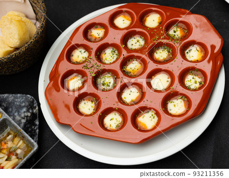 Tasty provolone cheese in molds. Served with bread and pickled vegetables. Uruguayan cuisine Tasty provolone cheese in molds. Served with bread and pickled vegetables. Uruguayan cuisine 93211356