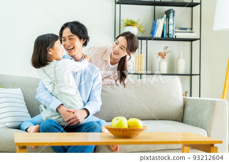 A young family relaxing in the living room A young family relaxing in the living room 93212604