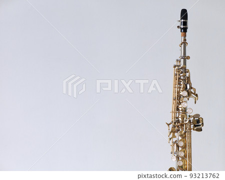 Golden Key Silver Plate Soprano Saxophone, Woodwind Instrumental Equipment on White Wall Background. Golden Key Silver Plate Soprano Saxophone, Woodwind Instrumental Equipment on White Wall Background. 93213762