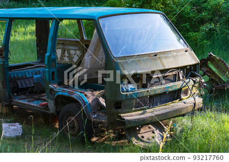 Abandoned car in the woods. Old, damaged car. Defective car. A car unfit for the roads. 93217760