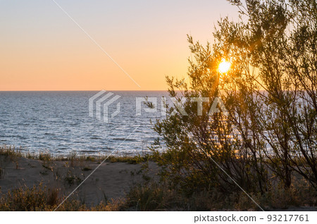 Sunset over the sea. Reflection of sunlight in the sea waves. Sunset over the sea. Reflection of sunlight in the sea waves. 93217761
