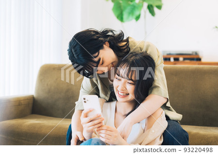 Female partners looking at smartphones 93220498