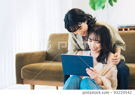 female partners looking at tablet 93220542
