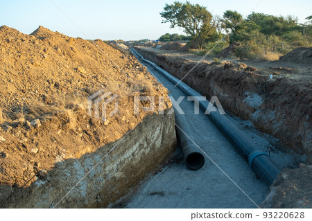 Deep trench in the ground for laying pipes. Water supply or sewerage. Construction site 93220628