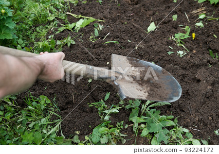 Human hands with shovel digging garden bed or farm. Farming, gardening, agriculture and people concept 93224172