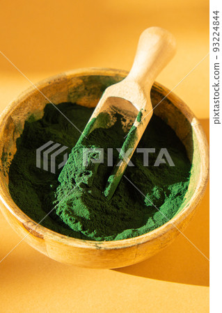 Blue-green algae Chlorella and spirulina powder in bamboo eco bowl. Super powder in spoon. Detox superfood. Natural supplement of algae Blue-green algae Chlorella and spirulina powder in bamboo eco bowl. Super powder in spoon. Detox superfood. Natural supplement of algae 93224844