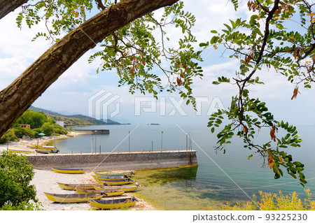 Stunning view of the shore of wonderful Skadar lake on the background of mountains. Amazing giant Skadar Lake is a famous bird nature reserve in Balkans located in Albania and Montenegro. 93225230