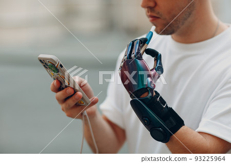 Young disabled man smoke electronic cigarette with artificial prosthetic hand in casual clothes Young disabled man smoke electronic cigarette with artificial prosthetic hand in casual clothes 93225964
