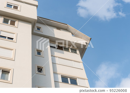 New modern residential building exterior against the sky. New modern residential building exterior against the sky. 93226008