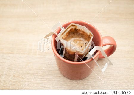 Coffee Drips in cup. Alternative brewing specialty coffee in paper filter bags. 93226520