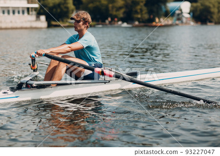 Sportsman single scull man rower rowing on boat. 93227047
