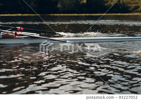 Sportsman single scull man rower rowing on boat. 93227052