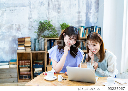Two young women planning a trip Two young women planning a trip 93227067