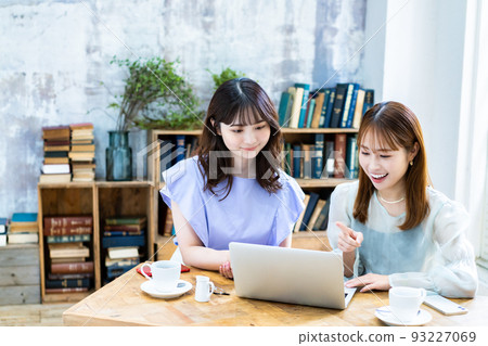 Two young women planning a trip Two young women planning a trip 93227069