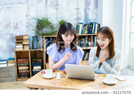 Two young women planning a trip Two young women planning a trip 93227070