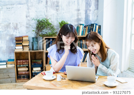 Two young women planning a trip Two young women planning a trip 93227075